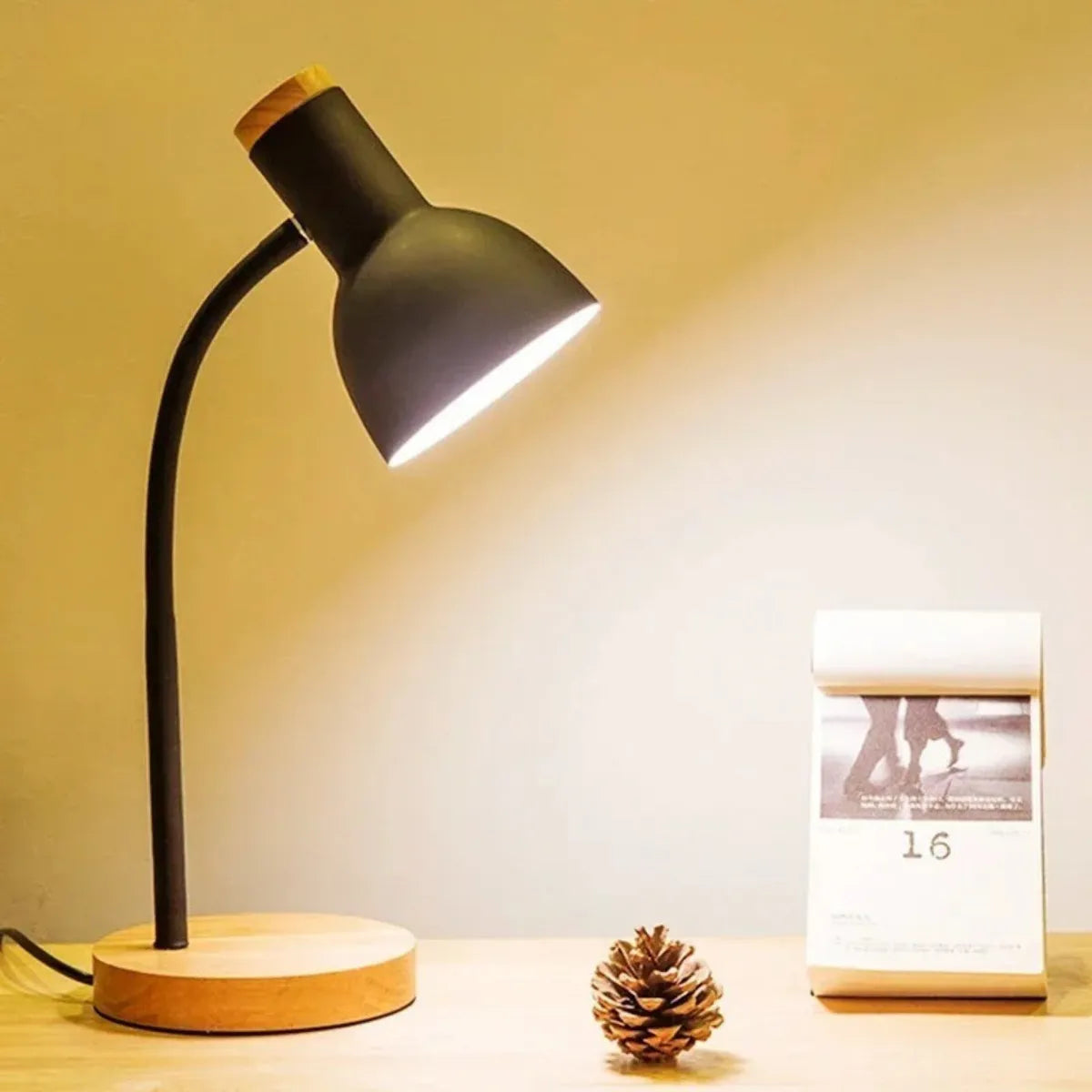 luminaria-abajur-de-mesa-led-curvada-preta-modernize-foto-luminaria-lateral-fundo-neutro-bege-iluminando-calendario