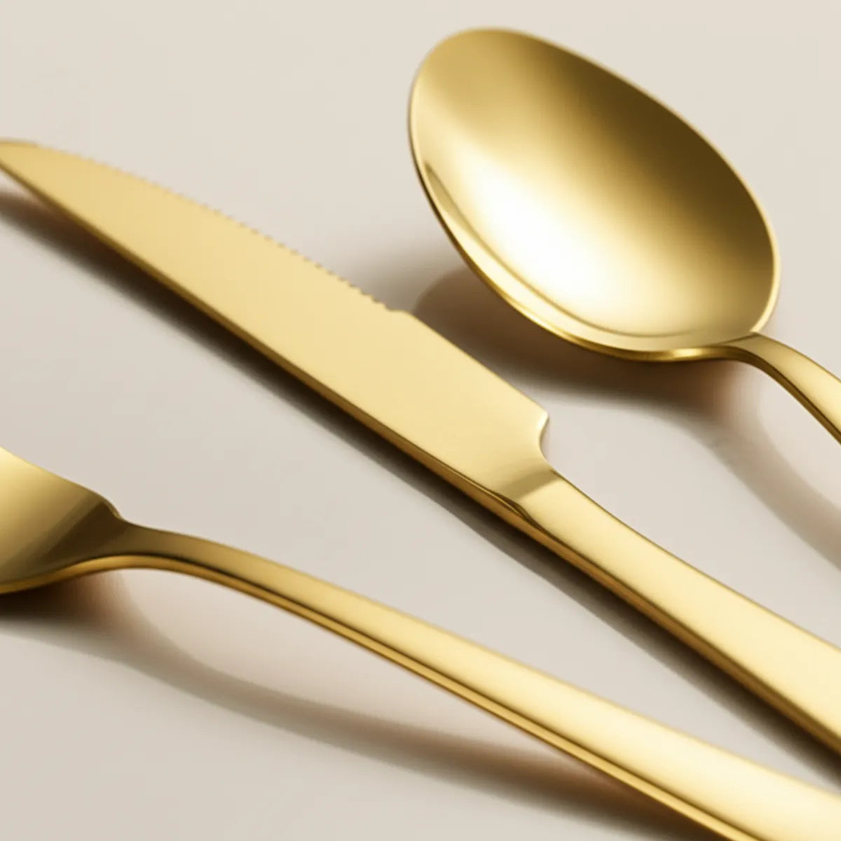 jogo-de-talheres-em-inox-golden-dourado-24-pecas-modernize-foto-zoom-talheres-dourados-em-fundo-bege